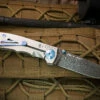 Spartan Blades Harsey Folder 3.25 Titanium / Blue 3.25" Nichols DamascusBlade SF10CNBL -KNIFECOMMAND Sales SPARTAN HARSEY 3.25 DAMASCUS BLUE 21950.1679767050.1280.1280