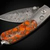 Glow Titanium Pocketknife Inlaid With Zinc-matrix Apple Coral. 1 Glow Titanium Pocketknife Inlaid With Zinc-matrix Apple Coral. -KNIFECOMMAND Sales b09 glow 1 2